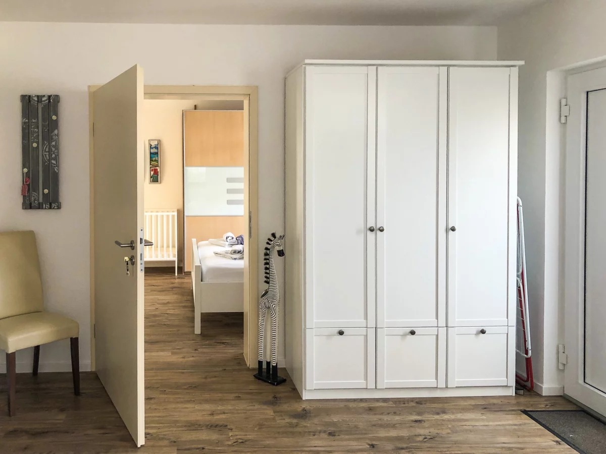 Blick von einem Schlafzimmer ins Durchgangsschlafzimmer mit Kleiderschrank in der Ferienwohnung Allensbach